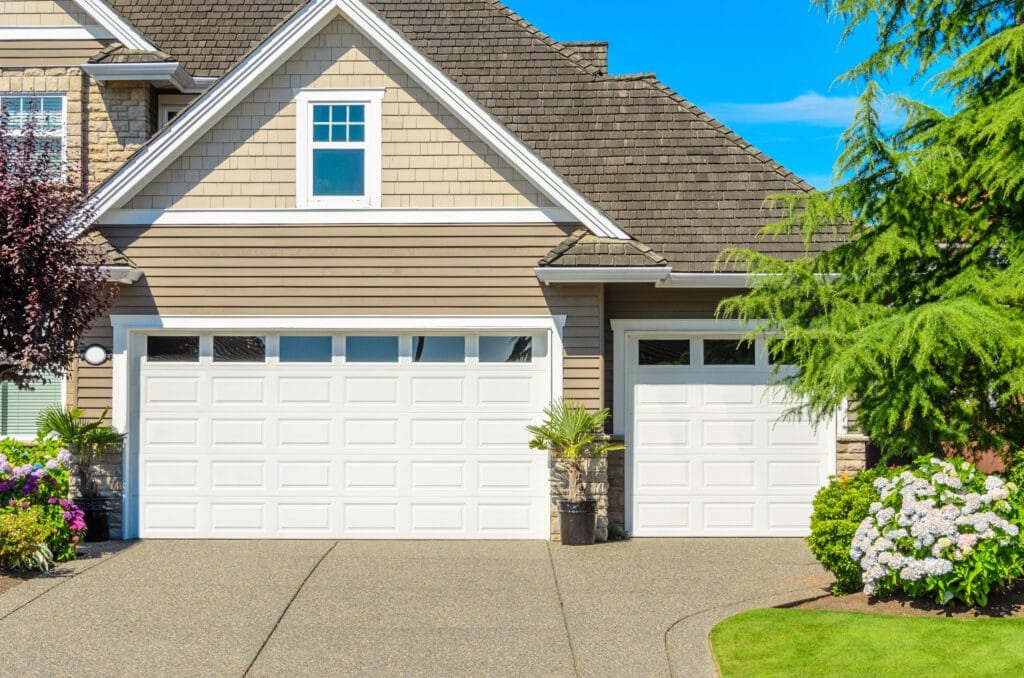 a white garage door in front of a house.