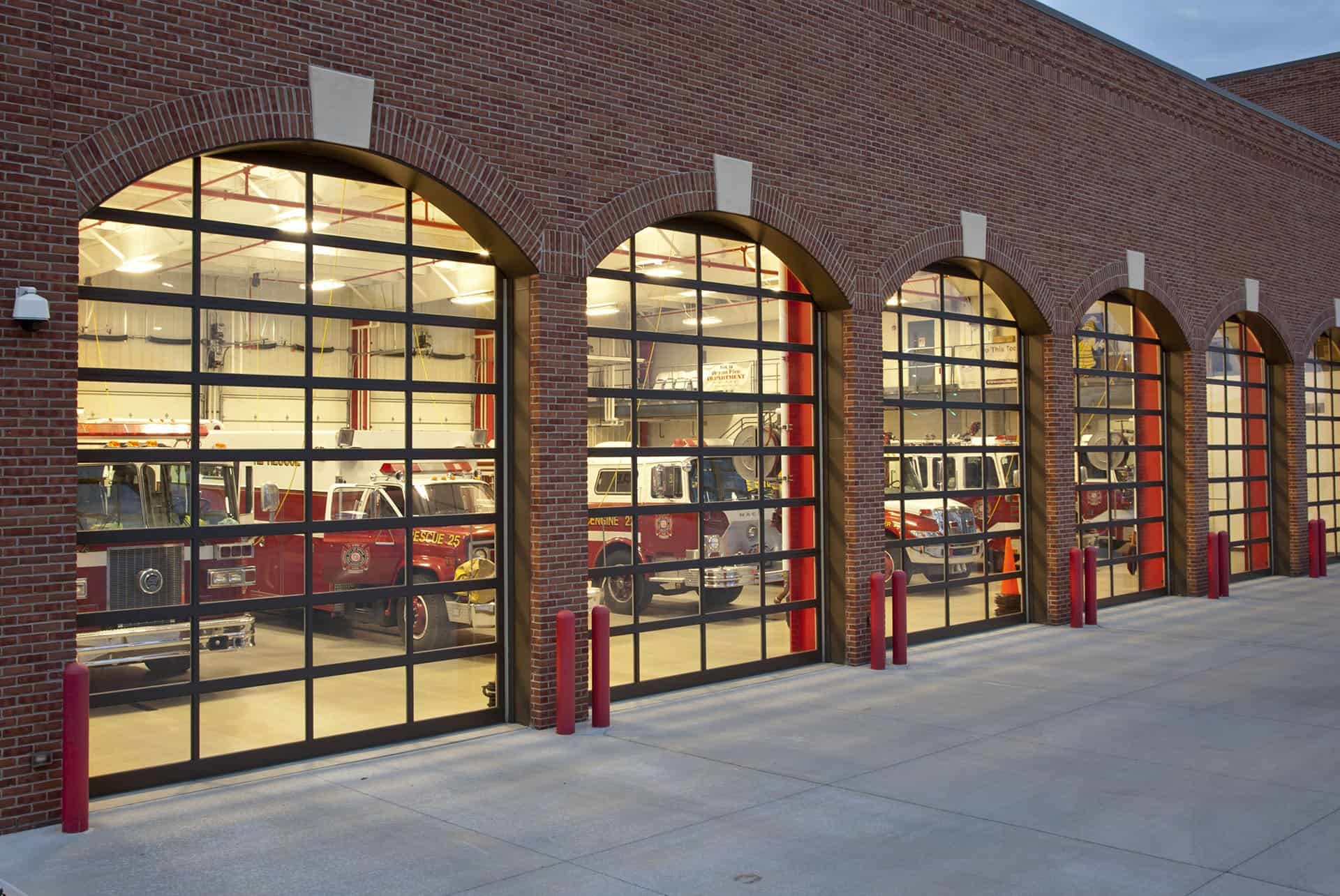a fire truck is parked in front of a brick building.