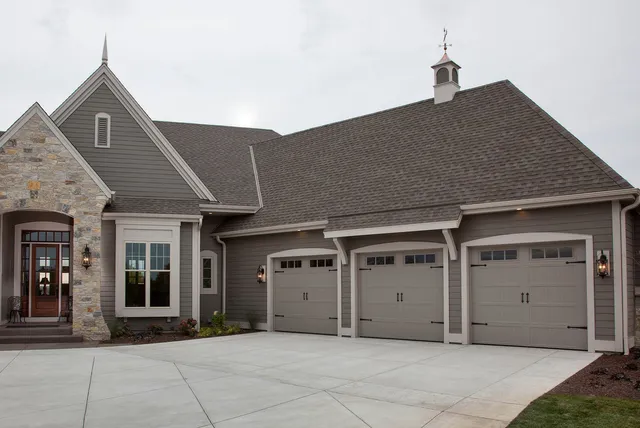beautiful home with gray garage doors